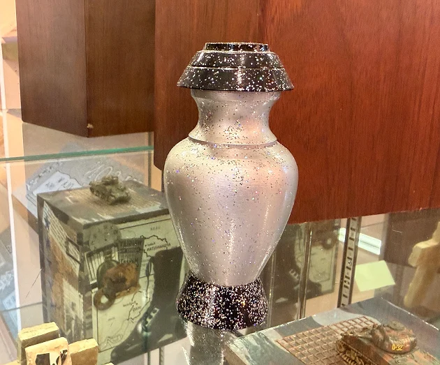 Elegant polished marble cremation urn vase with dark textured base and lid accents