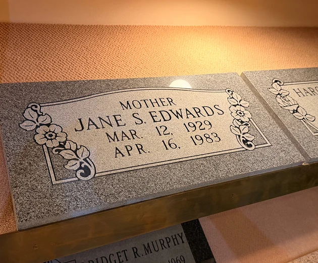 Single granite headstone marker engraved